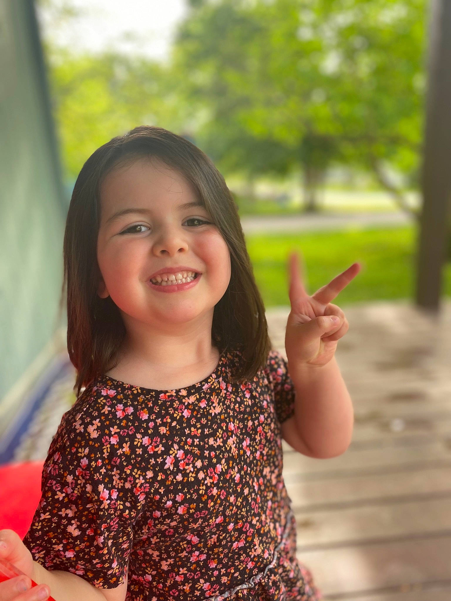 Mercy is registered to the contest to win money with this photo: arm, child, facial_expression, finger, flash_photography, fun, gesture, hand, happy, human_body, joy, leisure, people_in_nature, person, shoulder, skin, sleeve, smile, standing, thumb