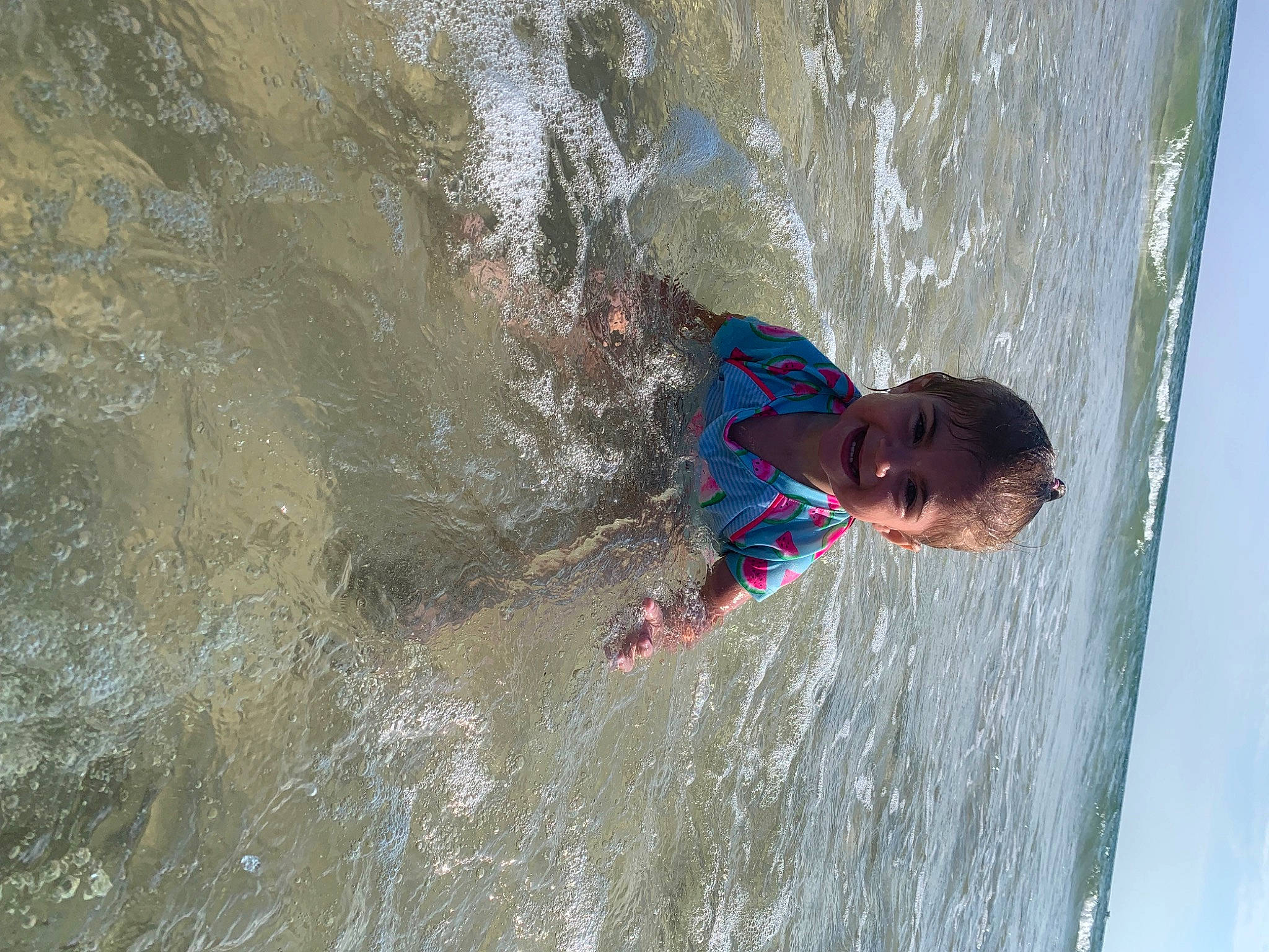 Zaria is registered to the contest to win money with this photo: adventure, bathing, beach, body_of_water, fluid, fun, joy, lake, leisure, ocean, person, recreation, stream, toddler, vacation, water, water_feature, wave, wind_wave