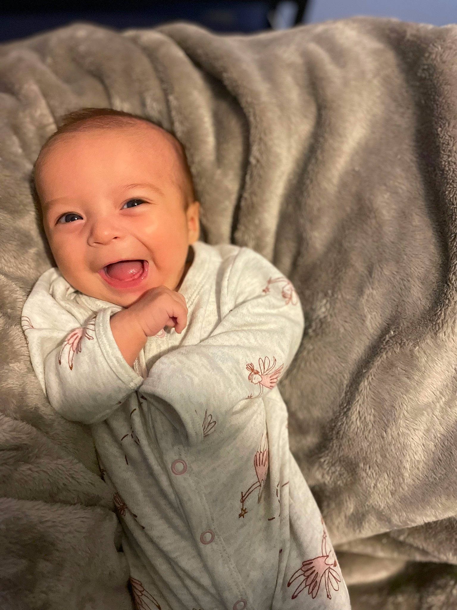 Harper is registered to the contest to win money with this photo: baby, baby_toddler_clothing, cheek, comfort, face, flash_photography, gesture, happy, head, iris, linens, lip, mouth, nose, outerwear, person, skin, sleeve, smile, textile