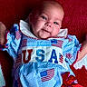 Violet joined the competition — help win amazing prizes! baby, child, infant, smile, face, clothing, usa, flag, red, blue, white, blanket, portrait, cute, happy, person, lying_down, ribbon, pattern, head