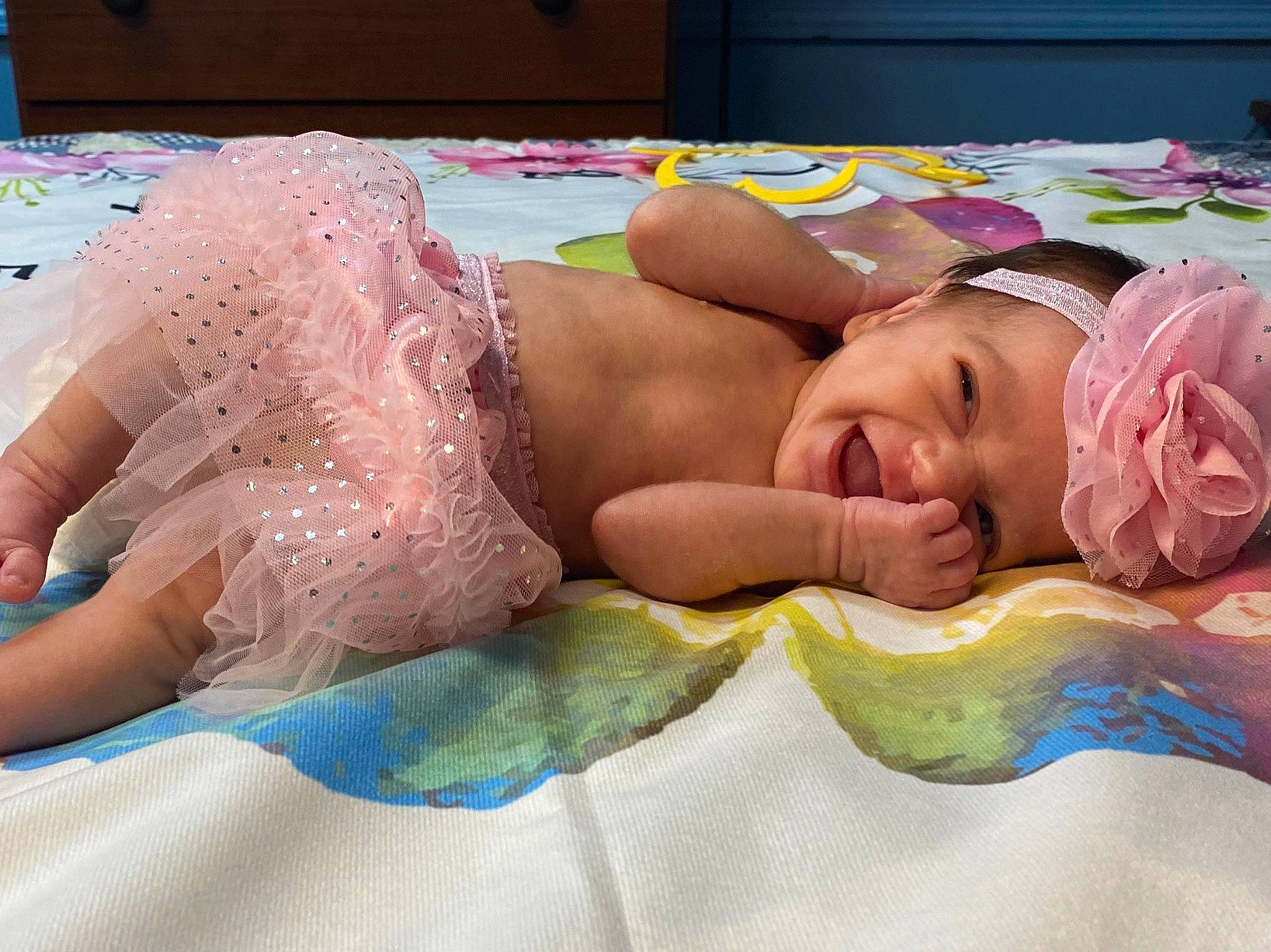 Naomi is registered to the contest to win money with this photo: abdomen, baby, bedding, bedtime, chest, child, comfort, eyebrow, finger, fun, happy, headpiece, headwear, leisure, linens, muscle, pattern, person, pink, skin