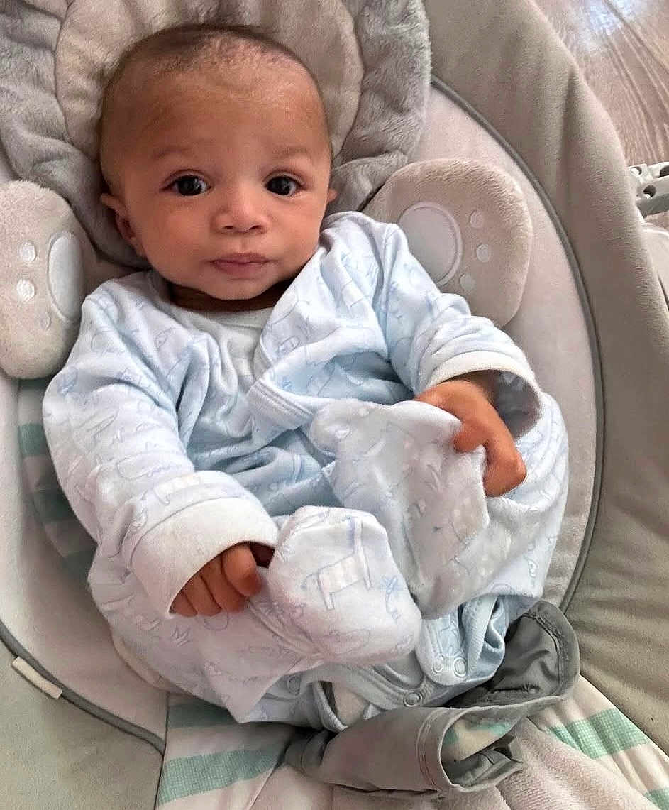 Jaylen joined the competition — help win amazing prizes! baby, infant, child, blue_clothing, cushion, seat, face, hands, eyes, blanket, indoor, soft_toys, baby_garment, cute, portrait, newborn, relaxed, comfort, expression, young