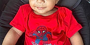 Kassim participe au concours pour gagner de l'argent avec cette photo : baby, bright, child, curly_hair, cushion, cute, hand, happy, indoors, infant, legs, looking_at_camera, onesie, person, portrait, red_clothing, seat, skin, smile, spiderman