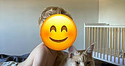 Aïko participe au concours pour gagner de l'argent avec cette photo : child, cat, bed, blanket, crib, indoor, furniture, smiling_emoji, hair, light, wall, room, relaxing, animal, pet, cute, domestic, fur, portrait, home