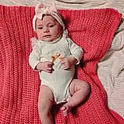 Isabella joined the competition — help win amazing prizes! baby, infant, headband, bow, blanket, knitted, white_clothing, cute, lying_down, indoors, soft_texture, child, newborn, peaceful, small_hands, small_feet, portrait, person, cozy, pink