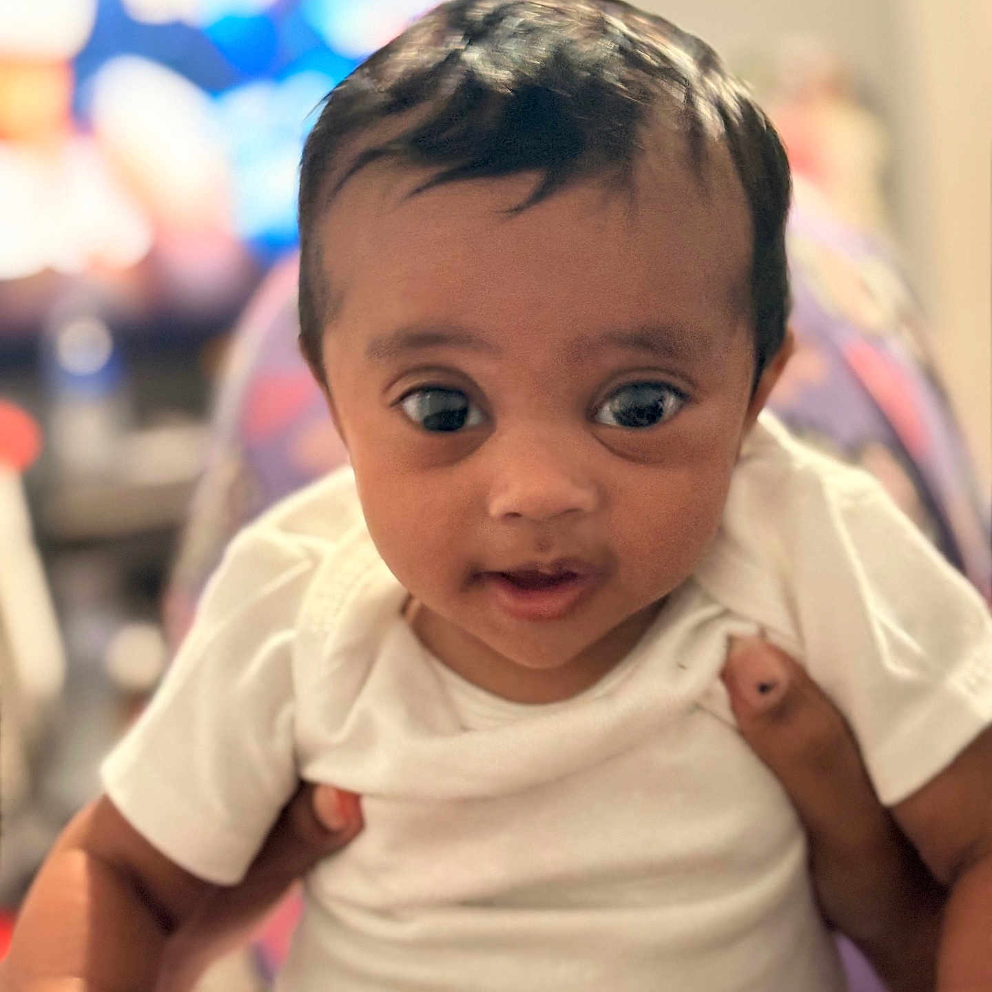 Zaria joined the competition — help win amazing prizes! baby, child, infant, person, white_clothing, holding, face, eyes, skin, head, portrait, indoor, blurred_background, cute, young, human, hands, expression, closeup, sitting