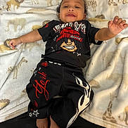 Nazavion joined the competition — help win amazing prizes! animal_print, baby, black_outfit, blanket, child, clothing, cute, elephant, foot, giraffe, hand, indoors, infant, lion, lying_down, person, red_graphics, smiling, soft_texture, white_graphics