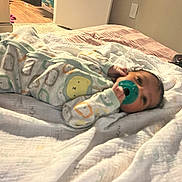 Nazavion joined the competition — help win amazing prizes! baby, pacifier, bed, blanket, onesie, animal_print, infant, sleepwear, indoors, carpet, doorway, flooring, game_controller, diapers, soft_lighting, child, cute, resting, home, cozy
