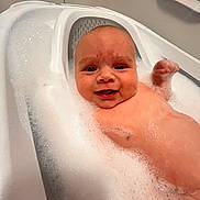 Christopher is registered to the contest to win money with this photo: baby, bath, bubbles, foam, bathtub, smile, child, water, skin, happy, face, infant, cute, relaxation, cleaning, bathroom, small, joy, playful, splash