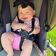 Azucena joined the competition — help win amazing prizes! baby, child, smiling, stroller, black_bow, headband, pink_clothing, polka_dot, baby_harness, outdoor, grass, sunlight, cute, chubby_legs, infant, happy, person, seat, safety_strap, portrait