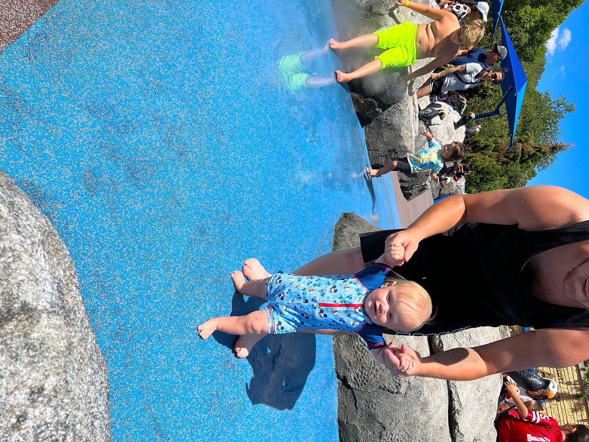 Braxton is registered to the contest to win money with this photo: adventure, competition_event, concrete, electric_blue, fun, grass, headwear, leisure, pattern, people_in_nature, person, recreation, shorts, sky, sneakers, sport_climbing, t_shirt, tourism, tree, vacation