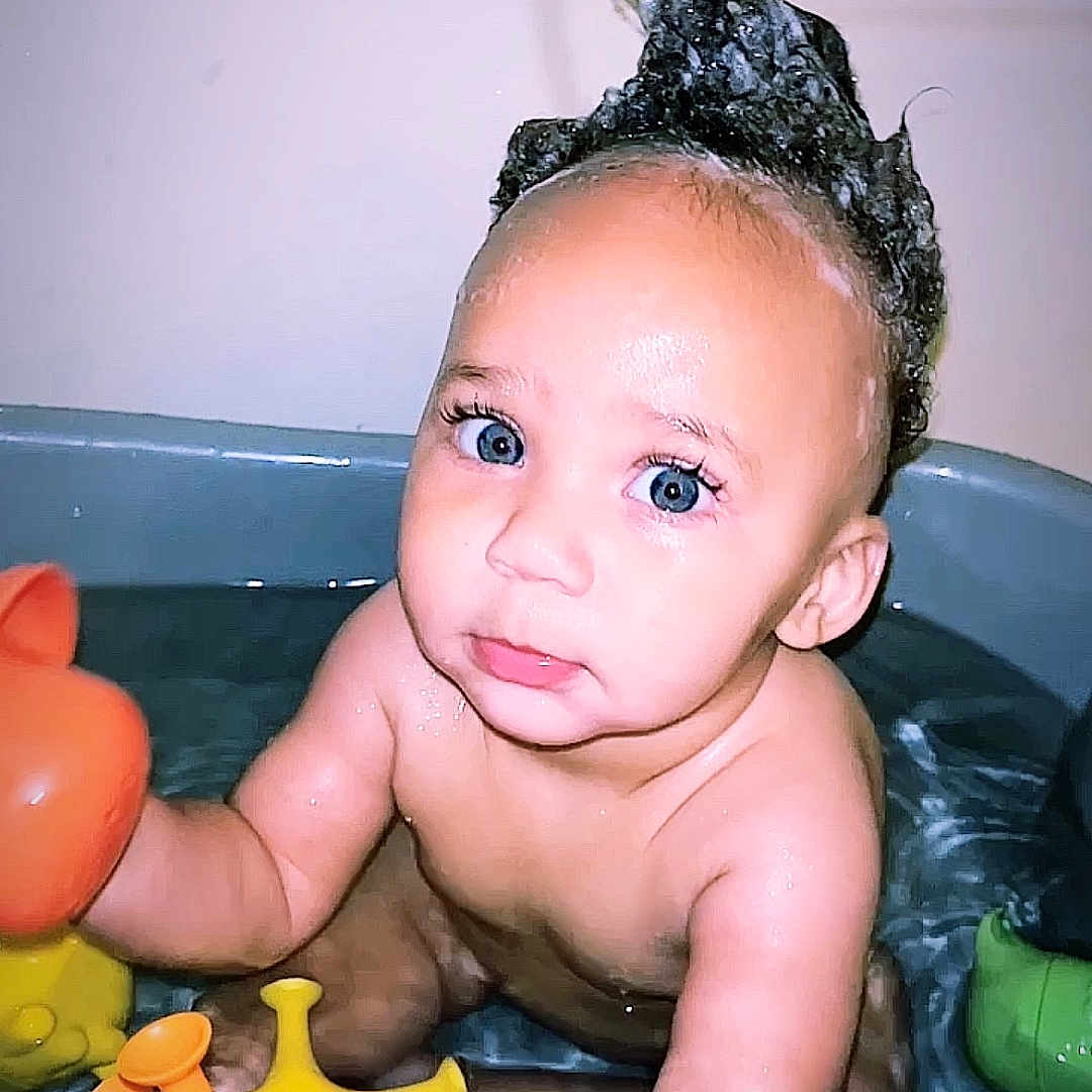 Zyaire is registered to the contest to win money with this photo: baby, bathing, bathtub, blackhair, bodypart, face, finger, hair, hand, happy, head, newborn, person, photography, portrait, smile, tub, washing