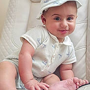 Isaac is registered to the contest to win money with this photo: baby, child, infant, smiling, hat, clothing, sitting, cute, face, tongue, hand, foot, chair, quilted, indoors, portrait, happy, skin, expression, person