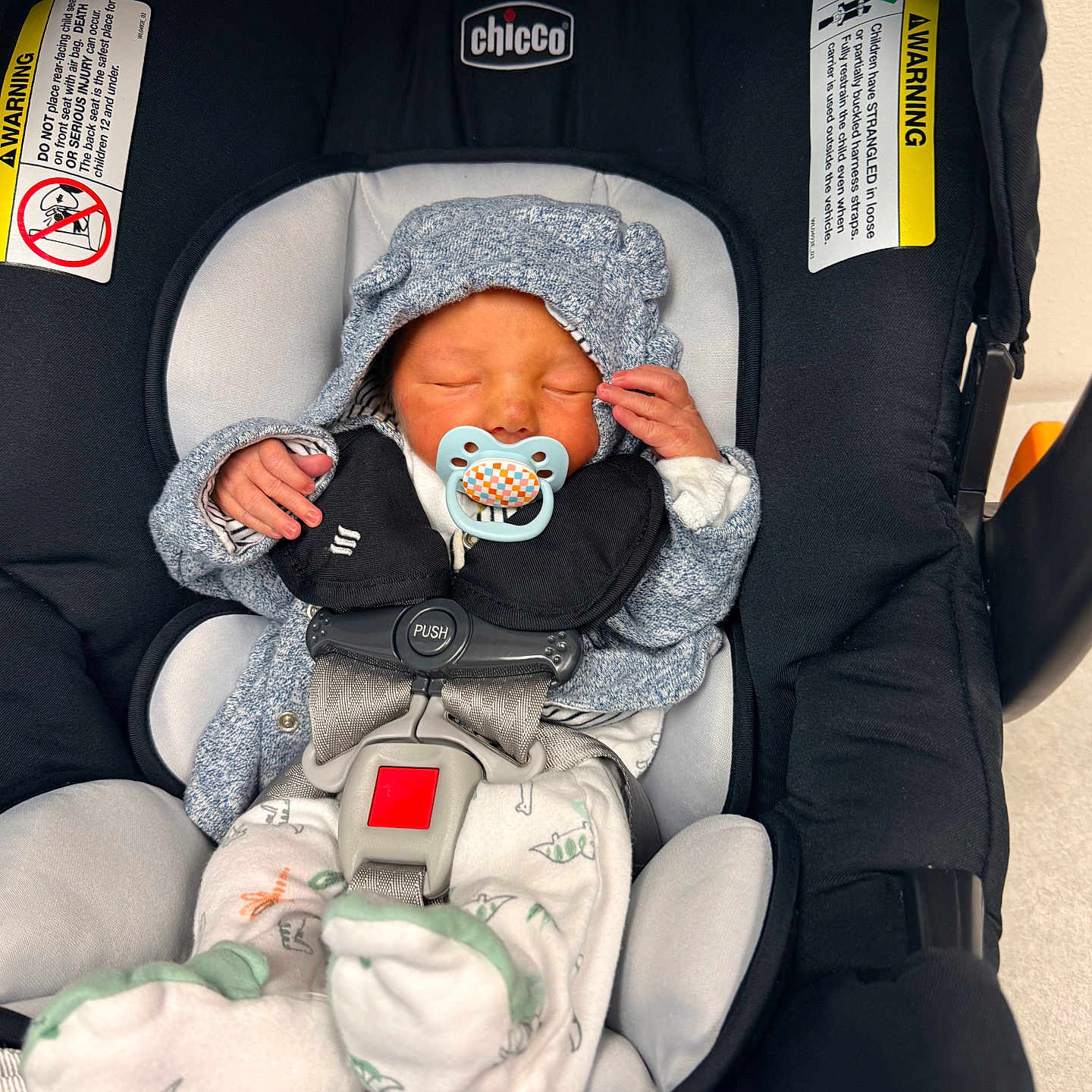 Kyzer is registered to the contest to win money with this photo: newborn, baby, pacifier, car_seat, chicco, infant, sleeping, clothing, hood, safety_harness, seat_belt, child, cute, indoor, soft_lighting, peaceful, wrapped, small_hands, footwear, resting
