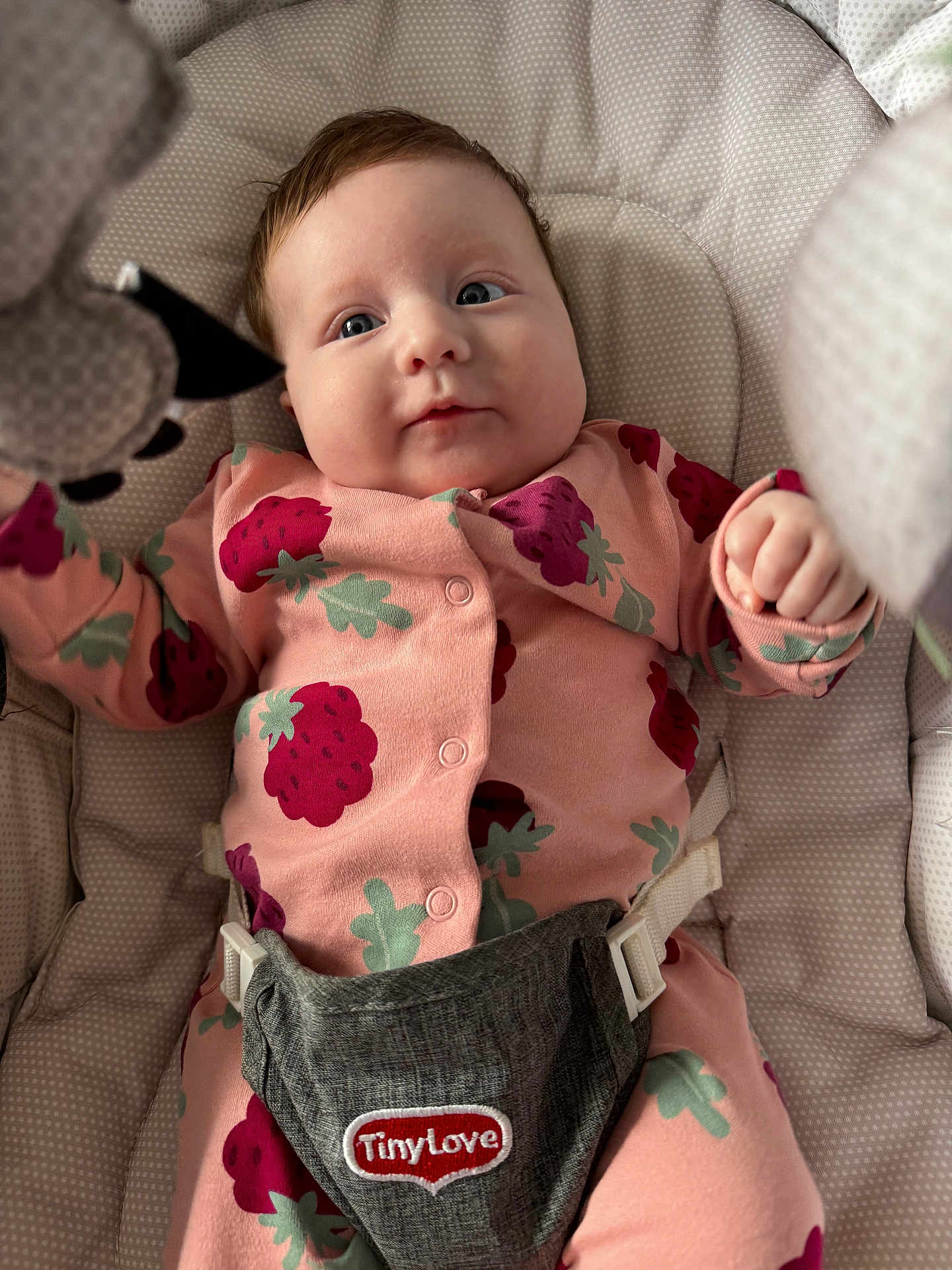 Ophelia joined the competition — help win amazing prizes! baby, infant, onesie, pink_clothing, strawberry_pattern, soft_toy, cushion, seat, child, cute, face, hand, comfort, indoor, portrait, expression, baby_girl, closeup, baby_boy, newborn