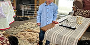 Lucas joined the competition — help win amazing prizes! carpet, child, clothing, couch, cup, curtains, floor, indoors, living_room, person, remote_control, rug, shoes, socks, table, television, toddler, toy, window, wooden_furniture
