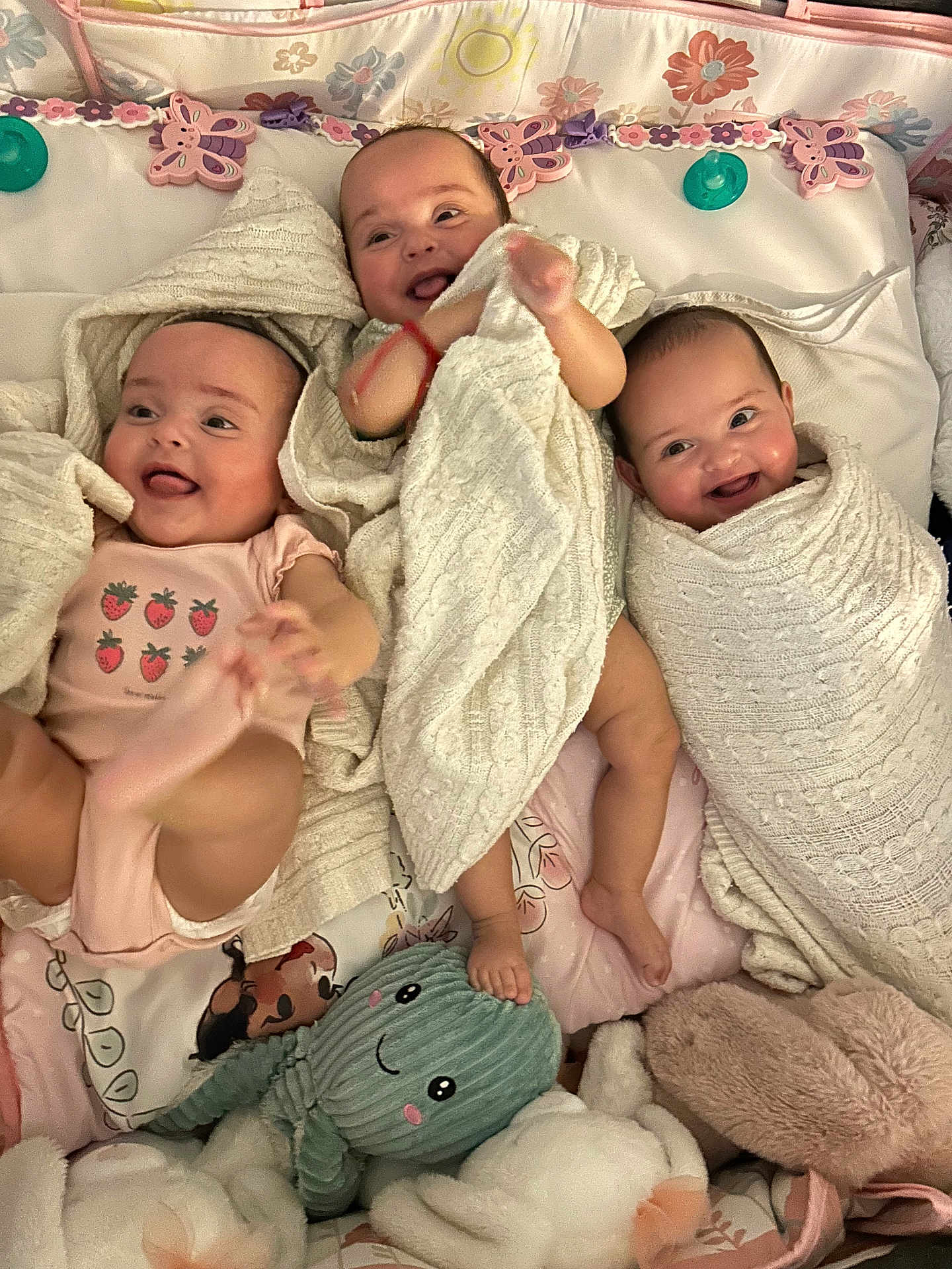 Jaretzzy is registered to the contest to win money with this photo: baby, infant, blanket, smiling, lying_down, crib, soft_toy, knitted_blanket, pink_onesie, cute, happy, swaddled, toddler, child, playful, indoor, cushion, floral_pattern, foot, head
