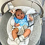 baby, infant, blue_shirt, baby_rocker, plush_toy, cloud_toy, bunny_toy, socks, indoor, child, face, hand, legs, seat, fabric, comfort, cute, looking_at_camera, soft, baby_accessory