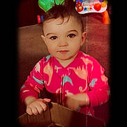 Hazel is registered to the contest to win money with this photo: toddler, child, pink_clothing, cardboard_box, indoor, playtime, toy, colorful, floor, carpet, face, portrait, curious, standing, young_child, baby, home, vignette, bright_colors, casual