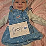 adorable, baby, baby_clothes, celebration, child, close_up, cute, denim_dress, face, headband, infant, lying_down, milestone_card, pink_blanket, portrait, small_person, smiling, soft_texture, two_months, white_tights