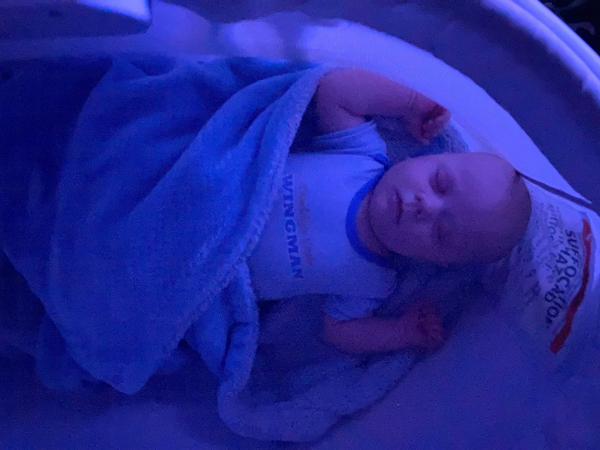 Leeroy is registered to the contest to win money with this photo: automotive_lighting, baby, baby_products, baby_toddler_clothing, child, comfort, electric_blue, fun, hand, hat, headgear, magenta, mouth, person, petal, purple, room, space, toddler, vehicle_door