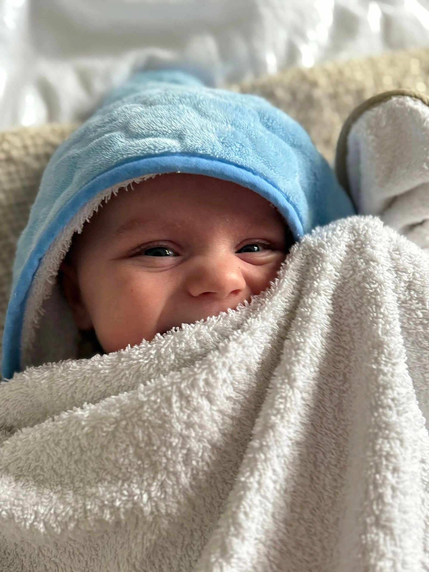 Bobby joined the competition — help win amazing prizes! baby, towel, blue_hood, face, eyes, blanket, soft_texture, cozy, infant, cute, smiling, closeup, child, indoors, warm, snuggly, portrait, happy, skin, head