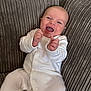 Bobby joined the competition — help win amazing prizes! baby, infant, smiling, happy, onesie, white_clothing, couch, fabric, texture, plush, comfort, indoor, child, face, expression, sitting, relaxation, cute, young, person