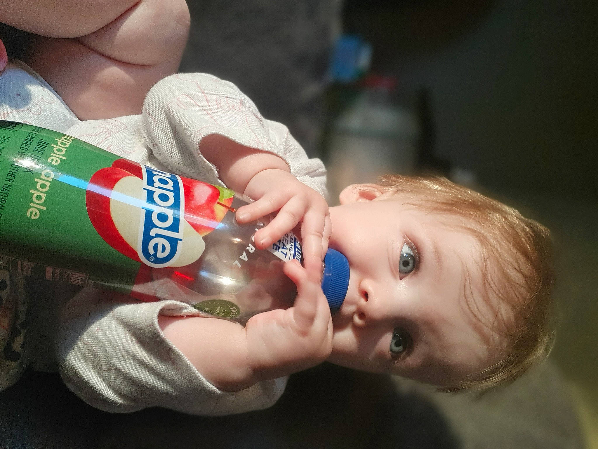 Sorriah is registered to the contest to win money with this photo: aluminum_can, baby_bottle, bottle, bottled_water, cheek, drink, drinking, drinking_water, drinkware, eyelash, finger, food, gesture, nail, person, plastic_bottle, skin, thumb, tin_can, toddler