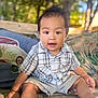 baby, bench, casual_clothing, child, cushions, cute, daylight, greenery, happy, nature, outdoor, person, plaid_shirt, portrait, shorts, sitting, smiling, toddler, wood, young