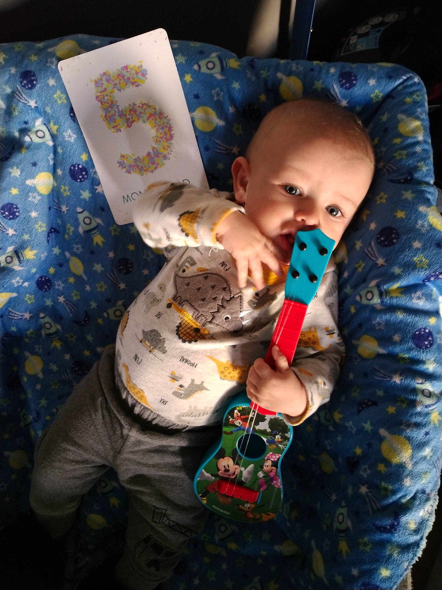 Asher is registered to the contest to win money with this photo: baby, baby_products, baby_toddler_clothing, carmine, cheek, child, comfort, fun, fur, happy, linens, pattern, person, personal_protective_equipment, play, room, sitting, sleeve, space, textile