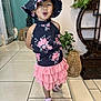 child, clothing, cute, dress, fashion, floral, footwear, furniture, girl, happy, hat, indoor, person, pink_skirt, plant, playful, pose, sandals, smiling, tile_floor