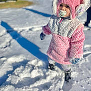 Jasmine joined the competition — help win amazing prizes! toddler, child, snow, winter_clothing, pink_coat, earmuffs, pacifier, outdoor, sunny, shadow, boots, cold_weather, cute, standing, frosty, winter_hat, playful, daylight, young_child, fun