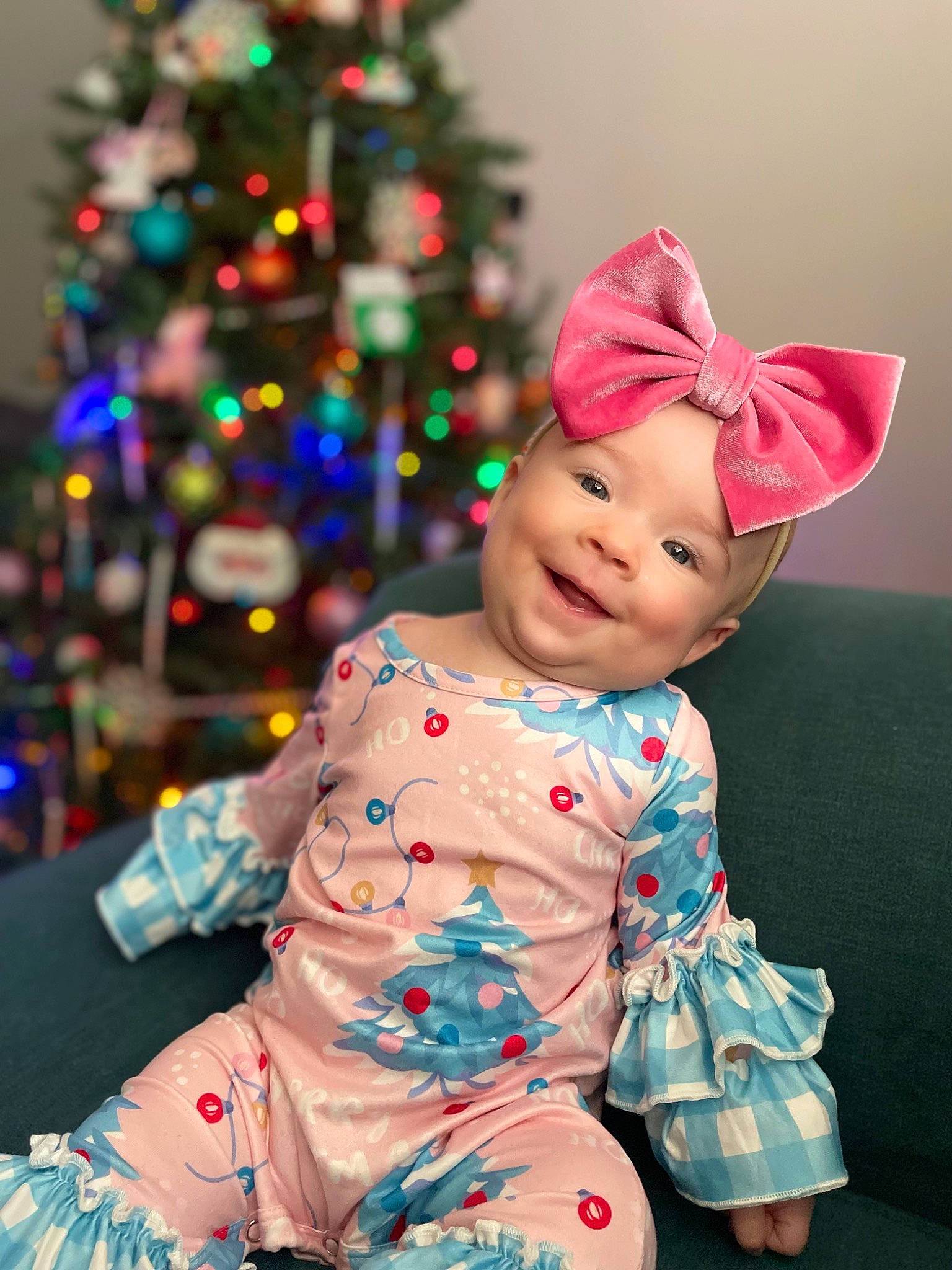 Jada is registered to the contest to win money with this photo: baby_toddler_clothing, christmas, christmas_ornament, christmas_tree, costume_hat, dress, event, face, fun, happy, head, headwear, holiday, joy, lighting, magenta, person, pink, purple, sleeve