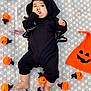Aaira joined the competition — help win amazing prizes! baby, bat, black_clothing, blanket, child, costume, cute, face, festive, footwearless, halloween, headwear, holiday, indoors, infant, lying_down, orange, portrait, pumpkin, string_lights