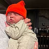Myan joined the competition — help win amazing prizes! baby, infant, sleeping, orange_hat, knit_hat, beige_clothing, cozy, hand, adult, indoor, soft_lighting, peaceful, portrait, close_up, cuddling, newborn, person, sleep, warmth, family