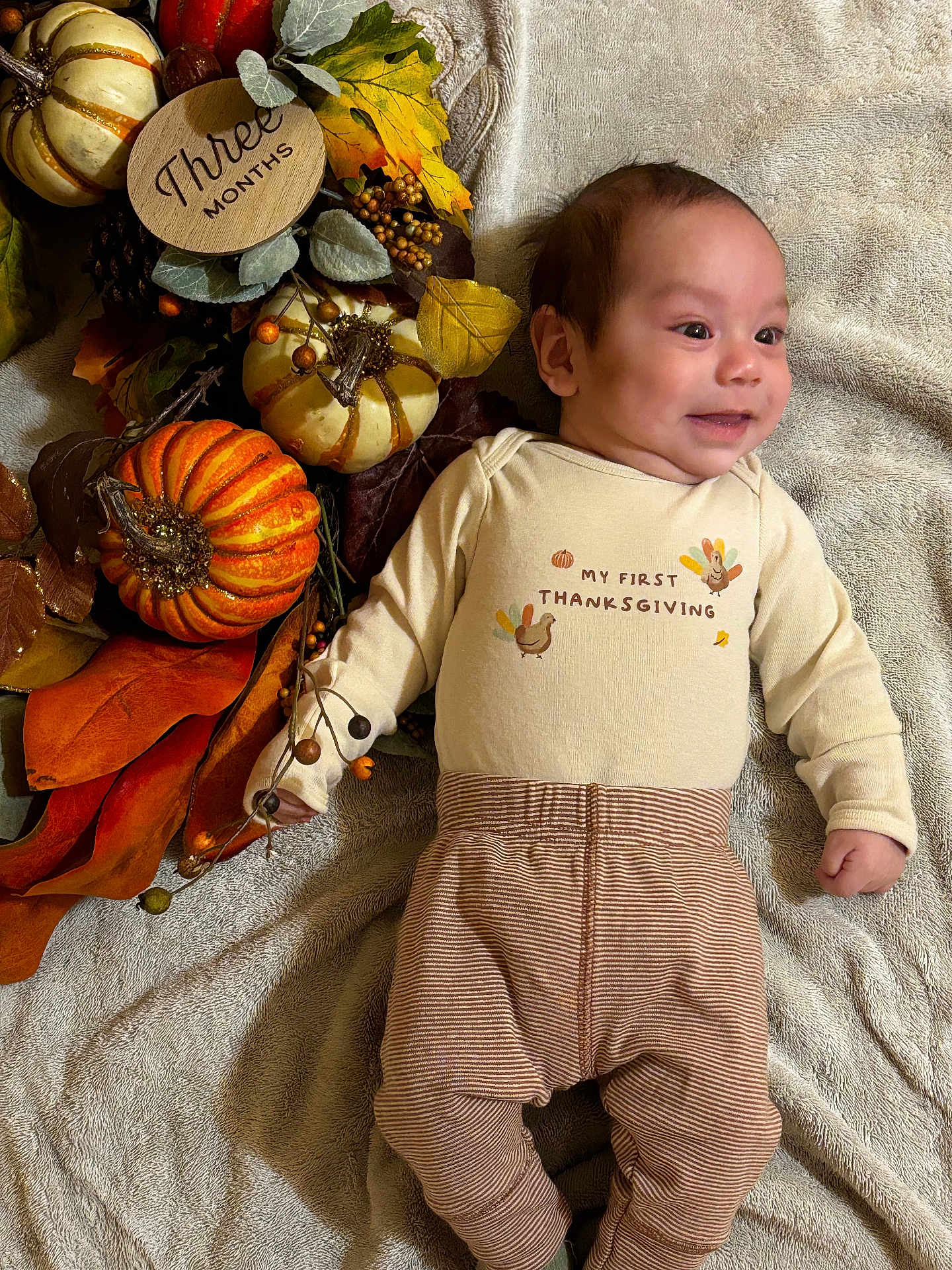 Francisco joined the competition — help win amazing prizes! baby, infant, smile, fall, autumn, pumpkin, thanksgiving, blanket, leaves, decoration, cozy, clothing, cute, holiday, milestone, wooden_sign, orange, brown, laying_down, happy