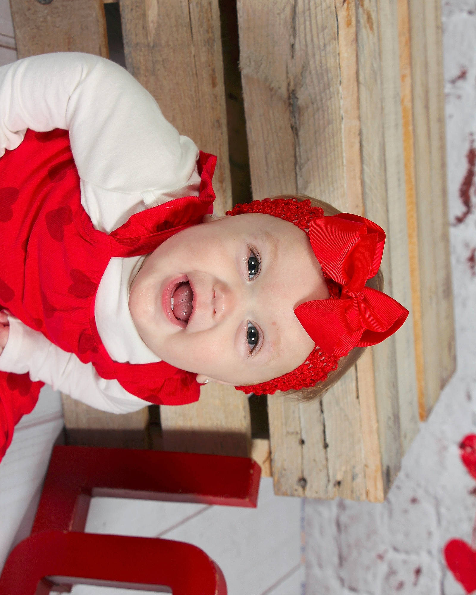 Adelynn is registered to the contest to win money with this photo: baby, baby_toddler_clothing, carmine, child, costume, event, fur, happy, hat, headwear, holiday, outerwear, pattern, person, sleeve, smile, toddler, winter, wood
