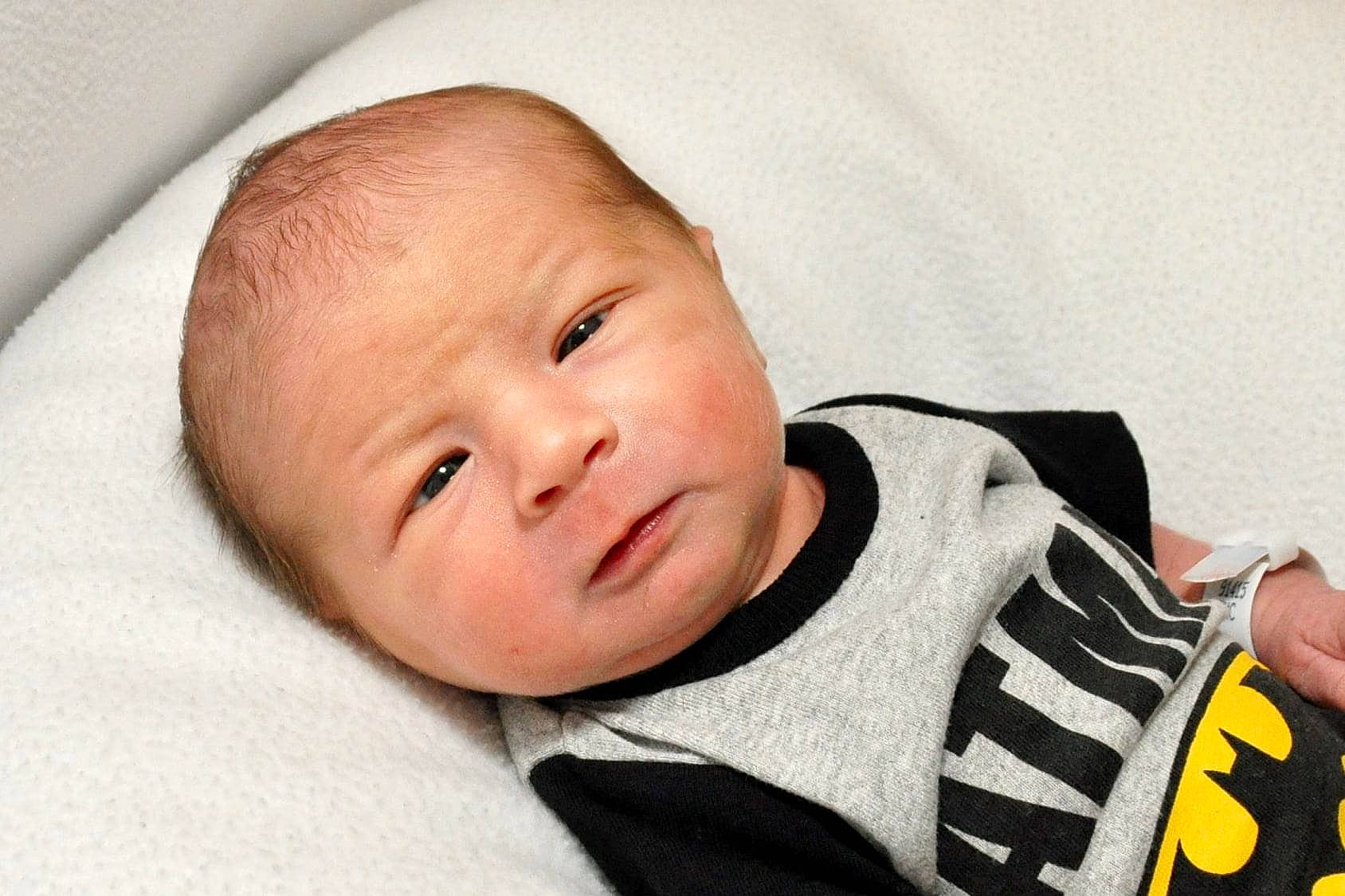 Coleson is registered to the contest to win money with this photo: baby, baby_products, baby_toddler_clothing, cheek, child, collar, comfort, eyebrow, eyelash, happy, iris, jersey, linens, person, portrait_photography, room, sitting, skin, sleeve, sportswear