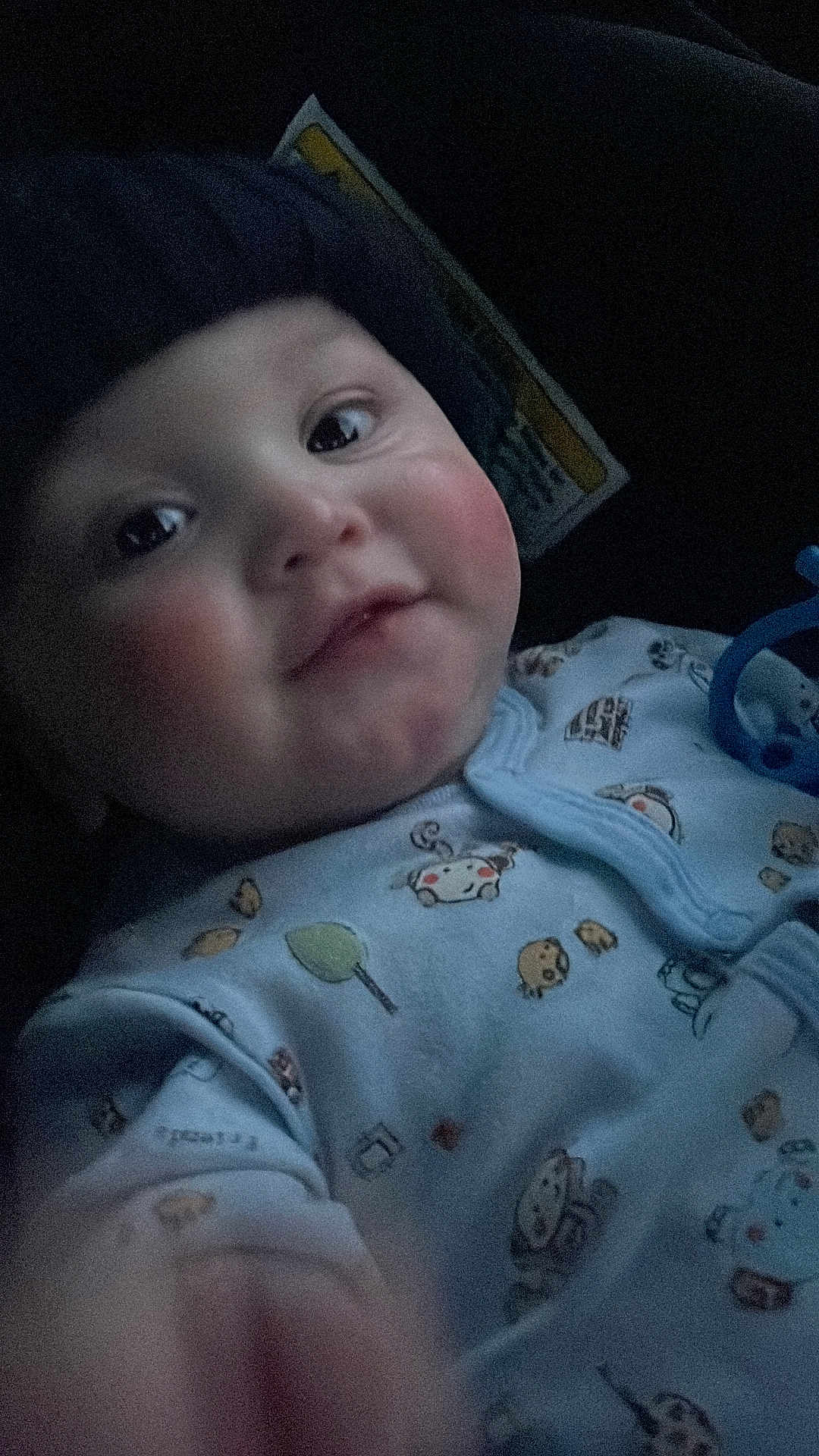 Eithan is registered to the contest to win money with this photo: baby, child, infant, smile, face, hat, clothing, onesie, animal_print, blue, cute, portrait, closeup, indoors, soft_lighting, warm, young, person, headwear, cozy