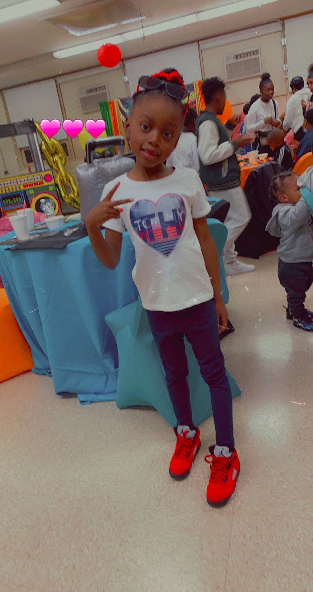 Ramiya Smith is registered to the contest to win money with this photo: chair, child, costume, electric_blue, event, fashion_design, flooring, footwear, fun, happy, head, kindergarten, leisure, person, recreation, room, sandal, shoe, sneakers, t_shirt