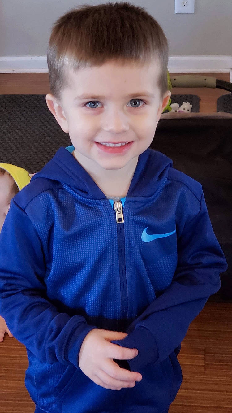 Lyric is registered to the contest to win money with this photo: arm, blond, blue, cheek, child, child_model, eye, face, facial_expression, hair, hairstyle, head, joy, male, outerwear, person, sitting, skin, sleeve, smile