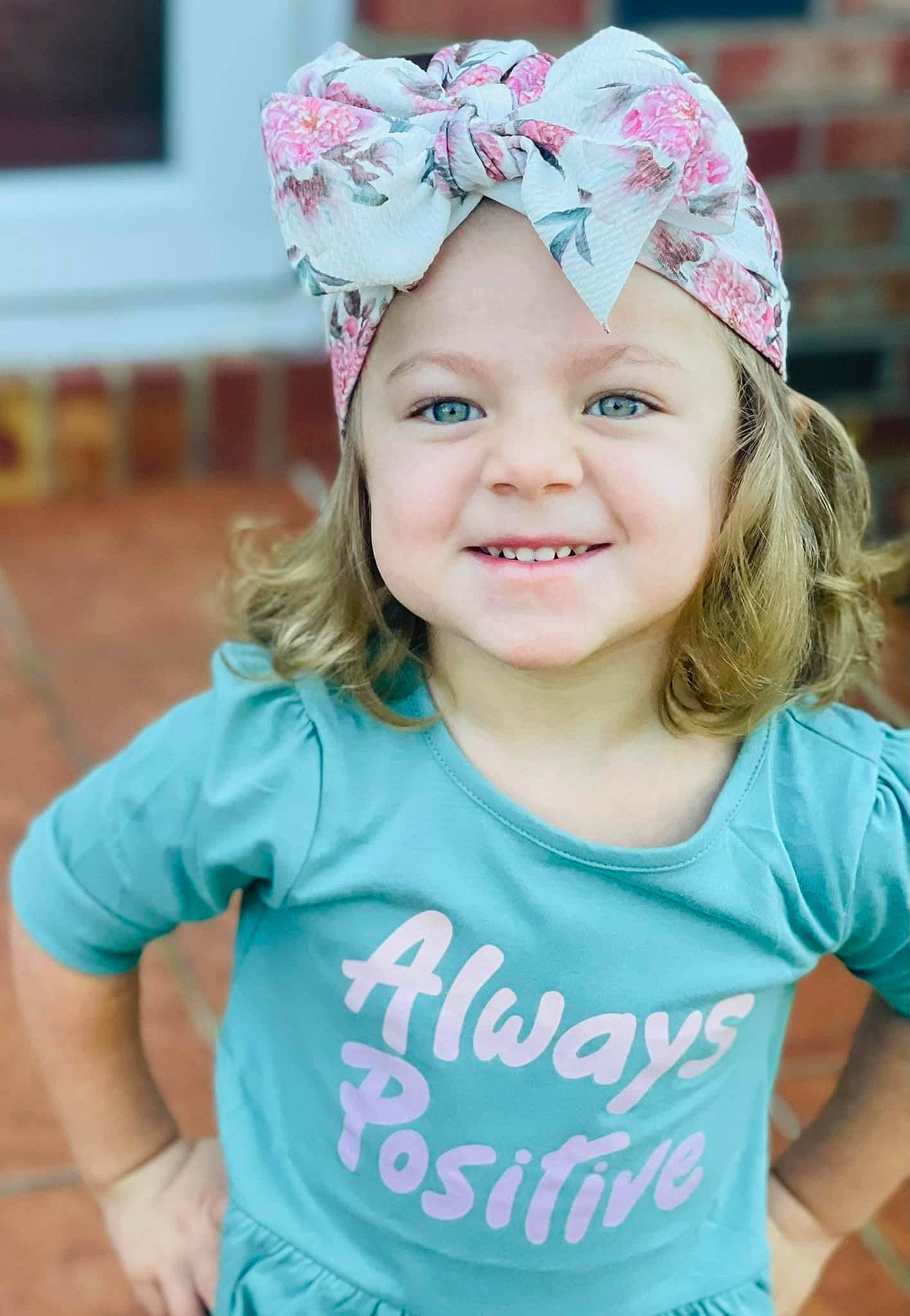 Maddie is registered to the contest to win money with this photo: aqua, blue, cap, clothing, cool, facial_expression, fun, grass, happy, hat, headgear, headpiece, headwear, joy, magenta, person, pink, sleeve, smile, summer