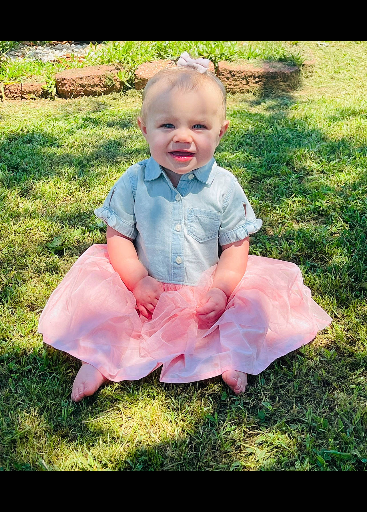 Lainey is registered to the contest to win money with this photo: baby, baby_toddler_clothing, child, dress, flash_photography, fun, garden, grass, grassland, happy, lawn, leisure, pattern, people_in_nature, person, pink, plant, portrait_photography, sitting, smile