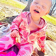 Gracelynn joined the competition — help win amazing prizes! baby, child, pink_clothing, heart_pattern, outdoor, sunlight, smiling, happy, eating, blanket, tree, grass, sandwich, playtime, nature, cute, toddler, casual, daytime, fun