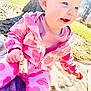 baby, child, outdoor, sunlight, tree, blanket, pink_clothing, heart_pattern, bread, smiling, happy, sitting, nature, grass, daylight, cute, person, head, face, hand