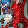 baby, infant, red_onesie, hat, cars_toys, book, milestone_card, four_months_old, lying_down, sucking_fingers, patterned_mattress, cute, child, face, eyes, hand, foot, toy_car, Disney, photography