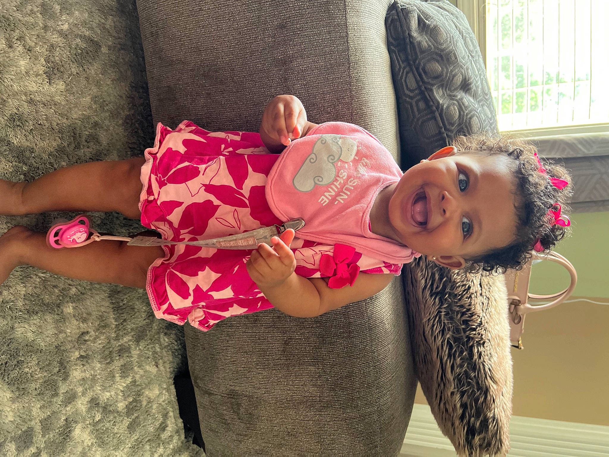 Kahlani is registered to the contest to win money with this photo: abdomen, baby_toddler_clothing, child, comfort, fashion_design, happy, human, human_leg, joint, magenta, mammal, person, pink, skin, sleeve, smile, thigh, toddler, trunk, waist