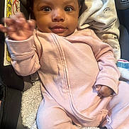 Tommie-Ronnaye is registered to the contest to win money with this photo: baby, blackhair, bodypart, clothing, coat, couch, cushion, face, finger, furniture, hand, happy, head, homedecor, jacket, pants, person, photography, portrait, smile