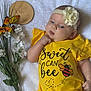 Rynleigh joined the competition — help win amazing prizes! baby, infant, yellow_clothing, headband, flower, bee_design, white_blanket, butterflies, orange_butterflies, bouquet, wooden_plaque, two_months, cute, child, portrait, soft_texture, resting, hand_near_mouth, milestone, lying_down