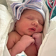 Rynleigh is registered to the contest to win money with this photo: newborn, baby, sleeping, hat, bow, blanket, hospital, infant, cute, wrapped, peaceful, skin, face, hands, closeup, portrait, child, soft, resting, cozy